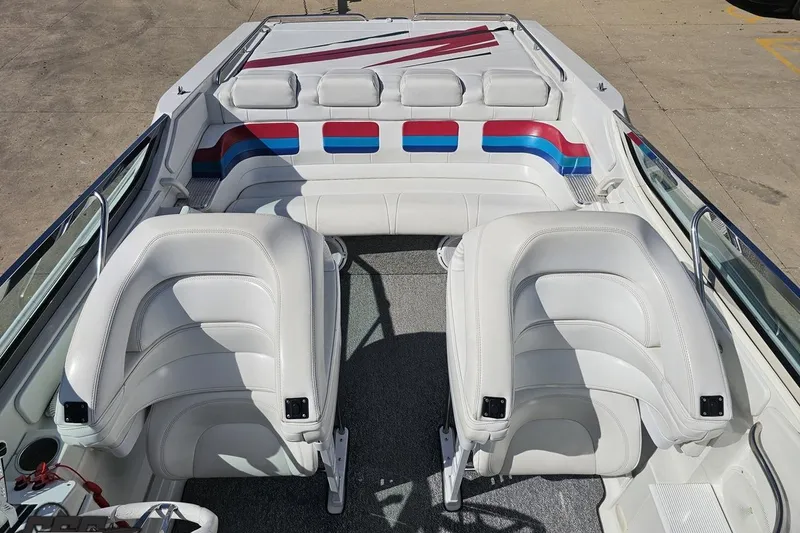 Slide: The Image of Interior of a 2001 Formula 382 FASTech boat with white seating and colorful accents. - 76