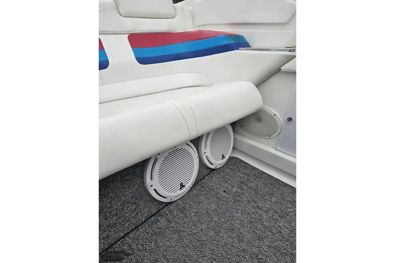 Slide: The Image of Interior of 2001 Formula 382 FASTech boat with white seating and marine speakers. - 90