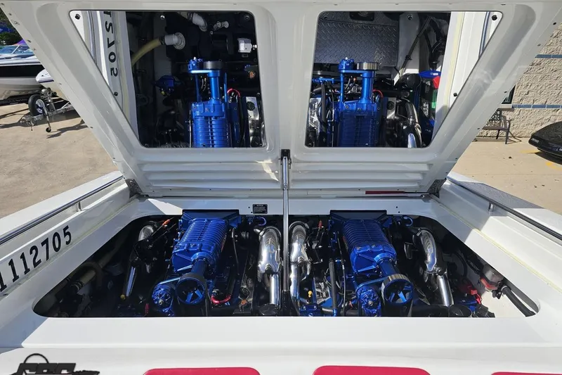 Slide: The Image of Open engine compartment of a 2001 Formula 382 FASTech boat, showcasing dual blue engines. - 94