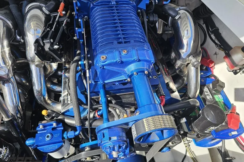 Slide: The Image of High-performance engine of a 2001 Formula 382 FASTech boat, featuring blue components and chrome details. - 98