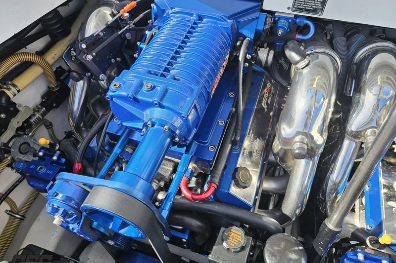 Slide: The Image of Engine of a 2001 Formula 382 FASTech boat, featuring a blue supercharger. - 99