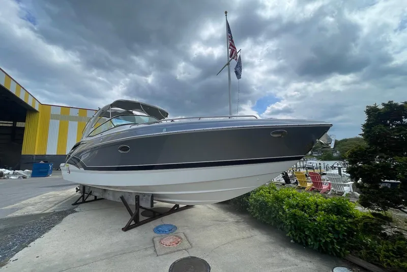 Slide: The Image of 2016 Formula 310 Bowrider boat on display, under cloudy sky, near a marina. - 4