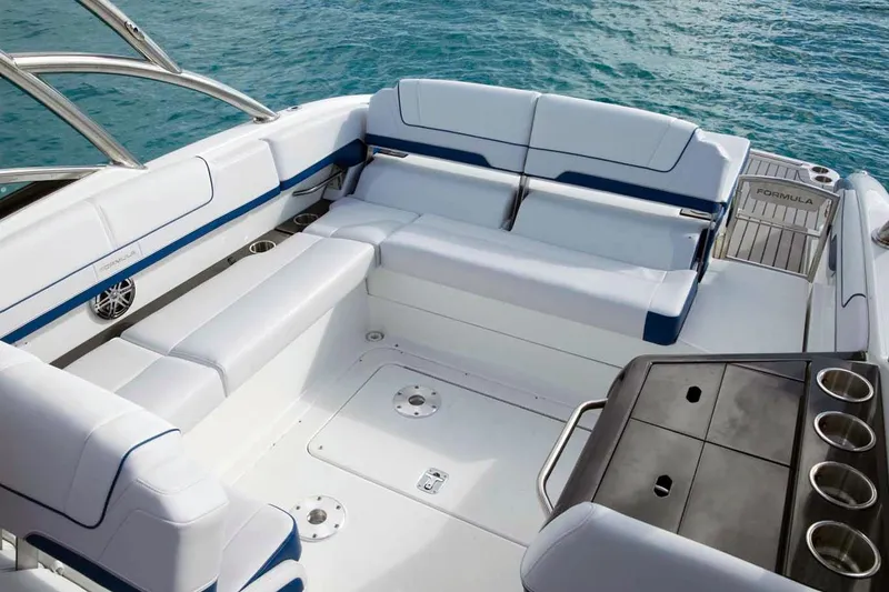 Slide: The Image of Manufacturer Provided Image: 2016 Formula 310 Bowrider boat interior with white and blue seating, ocean background. - 8
