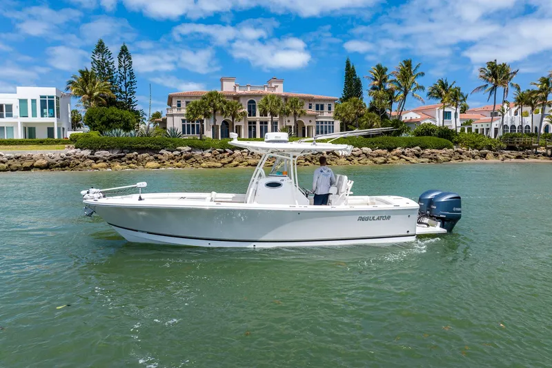 The Image of 2018 Regulator 28 boat cruising near luxury waterfront homes. - 0