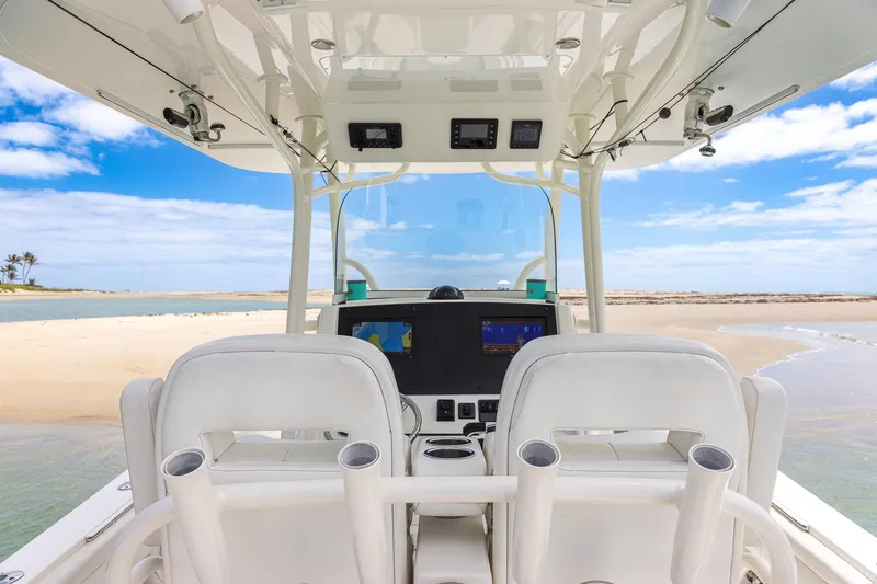 Slide: The Image of 2018 Regulator 28 boat interior with ocean view, featuring modern dashboard and seating. - 11