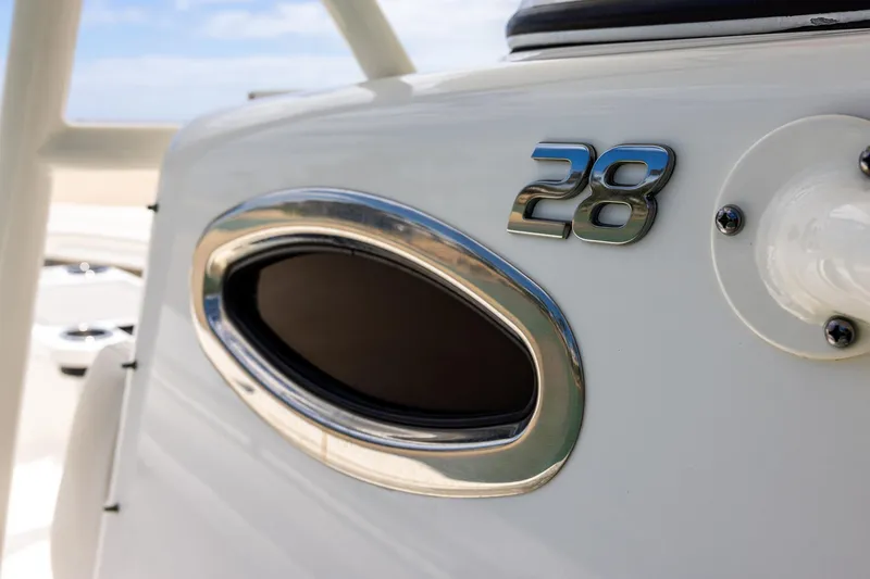 Slide: The Image of 2018 Regulator 28 boat detail with chrome accents and model number. - 14