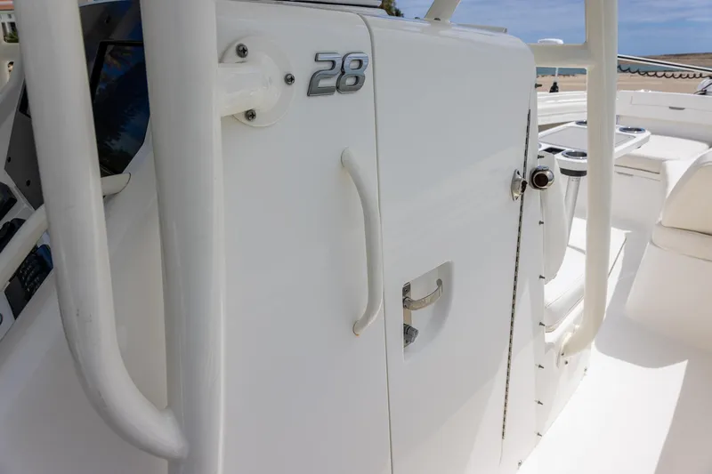 Slide: The Image of 2018 Regulator 28 boat console with white finish and sleek design. - 15