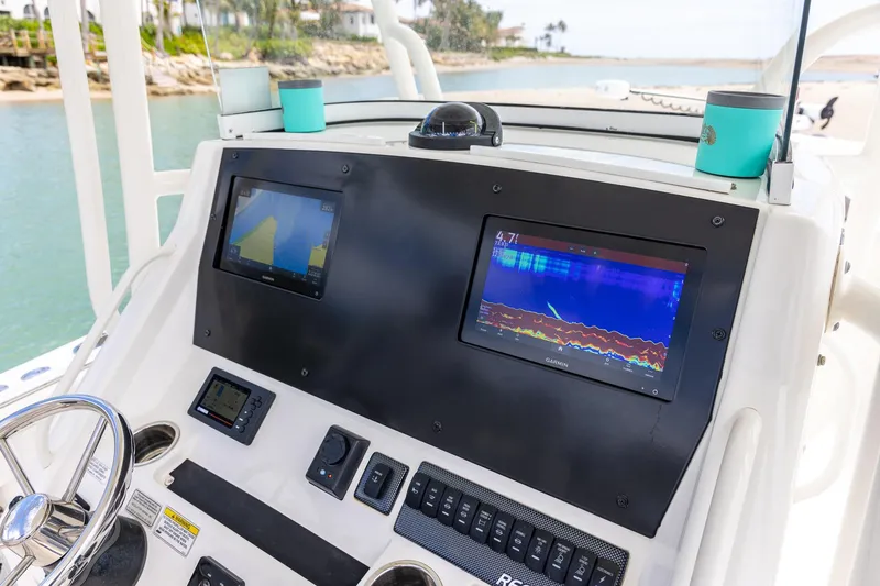 Slide: The Image of 2018 Regulator 28 boat dashboard with navigation screens and controls. - 17