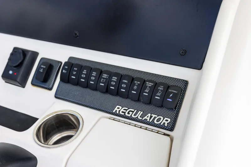 Slide: The Image of Control panel of a 2018 Regulator 28 boat with labeled switches. - 18