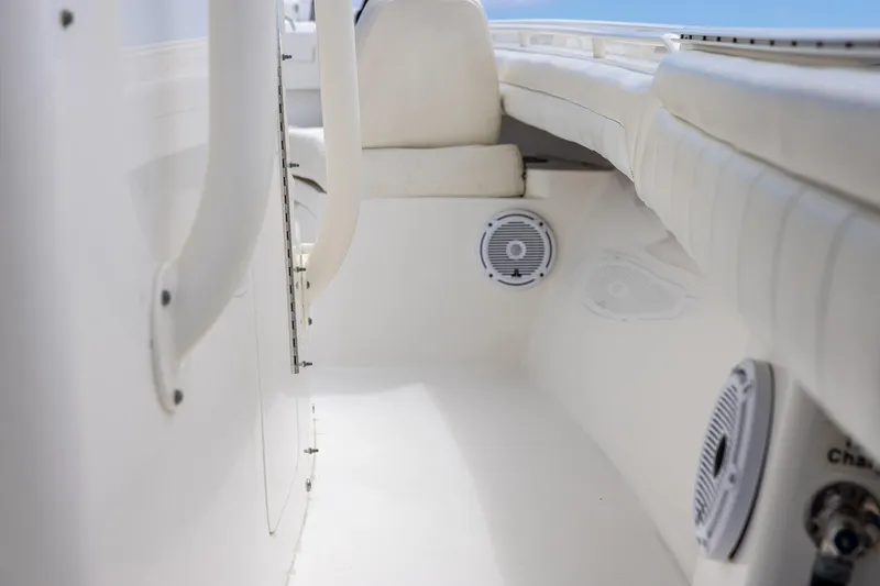 Slide: The Image of 2018 Regulator 28 boat interior with white seating and built-in speakers. - 23