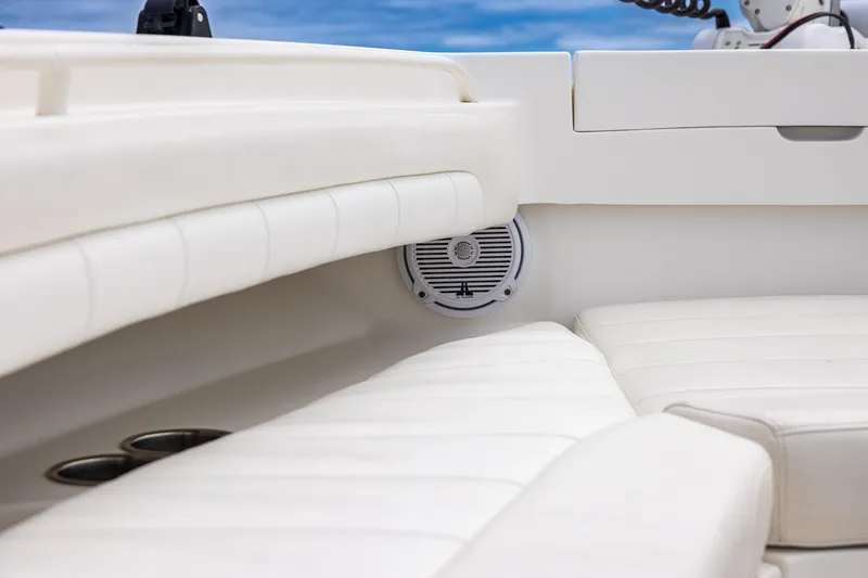 Slide: The Image of Interior of 2018 Regulator 28 boat with white cushioned seating and speaker. - 30