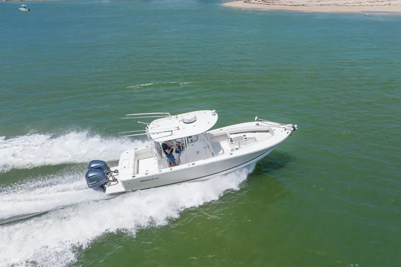 Slide: The Image of 2018 Regulator 28 boat cruising on open water, showcasing powerful twin engines. - 33