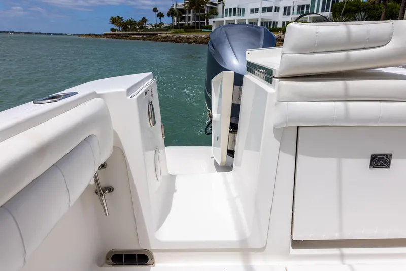 Slide: The Image of 2018 Regulator 28 boat interior with white seating and ocean view. - 6