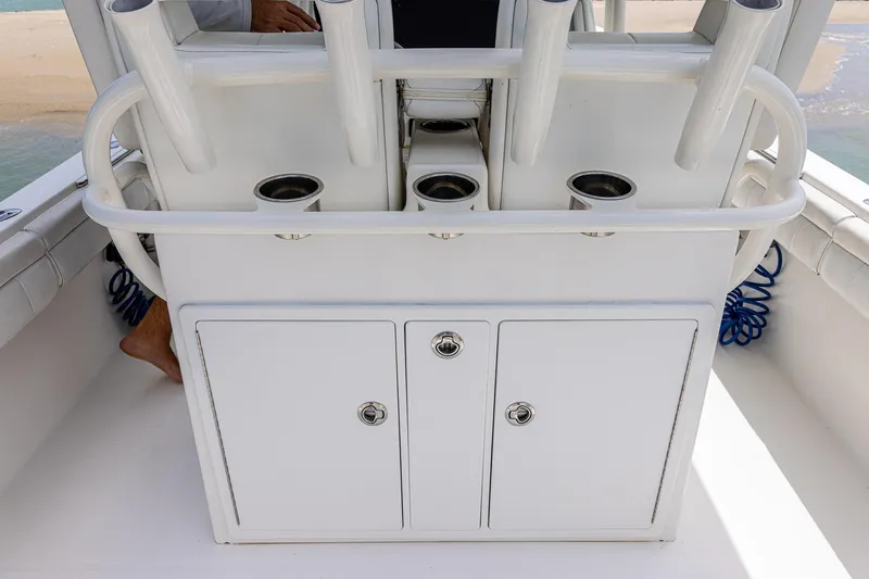 Slide: The Image of 2018 Regulator 28 boat console with rod holders and storage compartments. - 9