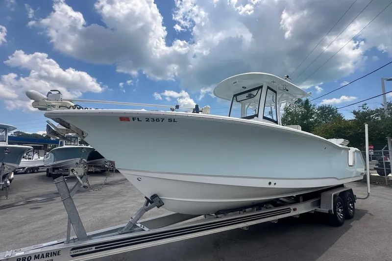 The Image of 2019 Sea Hunt Gamefish 27 Coffin Box boat on trailer under cloudy sky. - 0