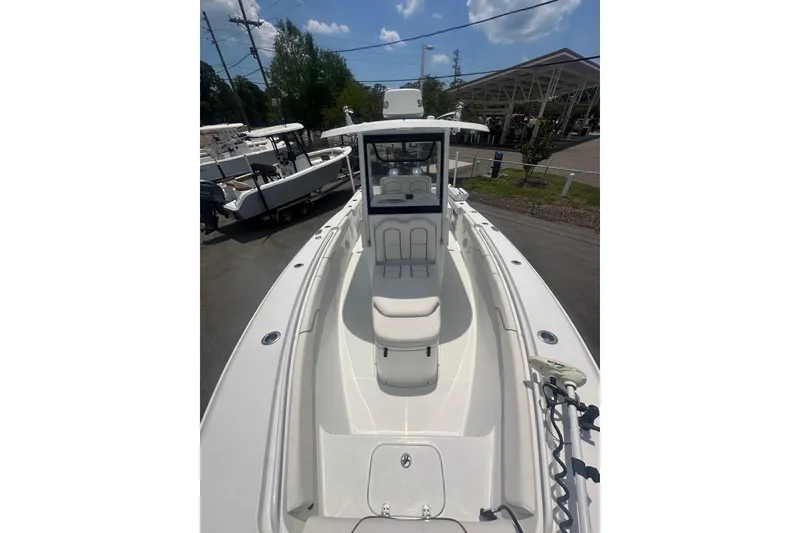 Slide: The Image of 2019 Sea Hunt Gamefish 27 Coffin Box boat, spacious deck, sleek design, parked outdoors. - 5