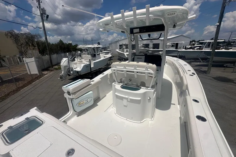 Slide: The Image of 2019 Sea Hunt Gamefish 27 Coffin Box boat, featuring spacious deck and modern console. - 6