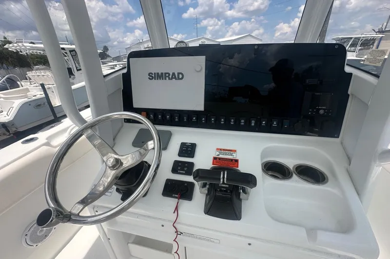 Slide: The Image of 2019 Sea Hunt Gamefish 27 Coffin Box helm with Simrad display and Yamaha controls. - 8