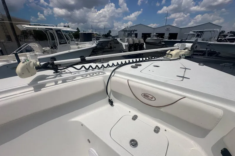 Slide: The Image of 2019 Sea Hunt Gamefish 27 Coffin Box boat deck with trolling motor, under a cloudy sky. - 9