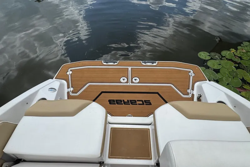 Slide: The Image of Rear view of 2015 Scarab 255 Platinum boat with water and lily pads. - 10