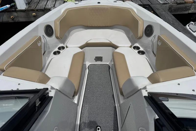 Slide: The Image of Interior of a 2015 Scarab 255 Platinum boat with beige seating and cup holders. - 3