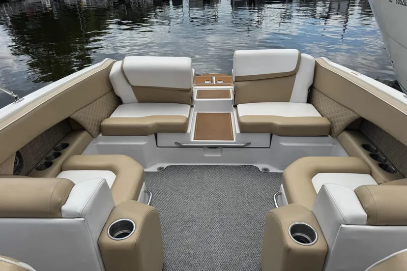 Slide: The Image of Interior of a 2015 Scarab 255 Platinum boat with beige and white seating. - 6