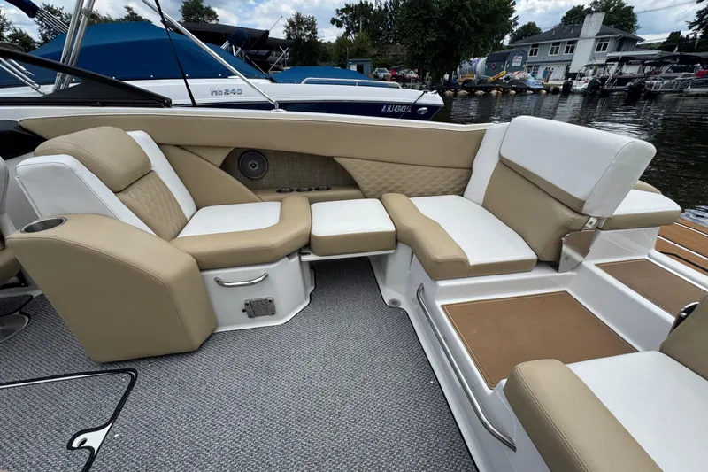 Slide: The Image of Luxurious seating on a 2015 Scarab 255 Platinum boat, featuring beige and white upholstery. - 7