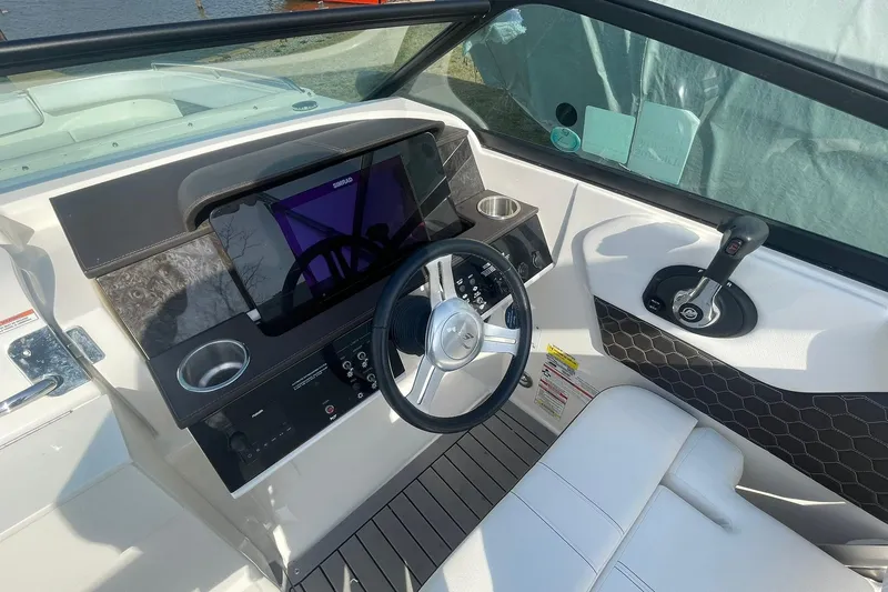 Slide: The Image of 2019 Sea Ray SDX 250 boat cockpit with steering wheel and control panel. - 10