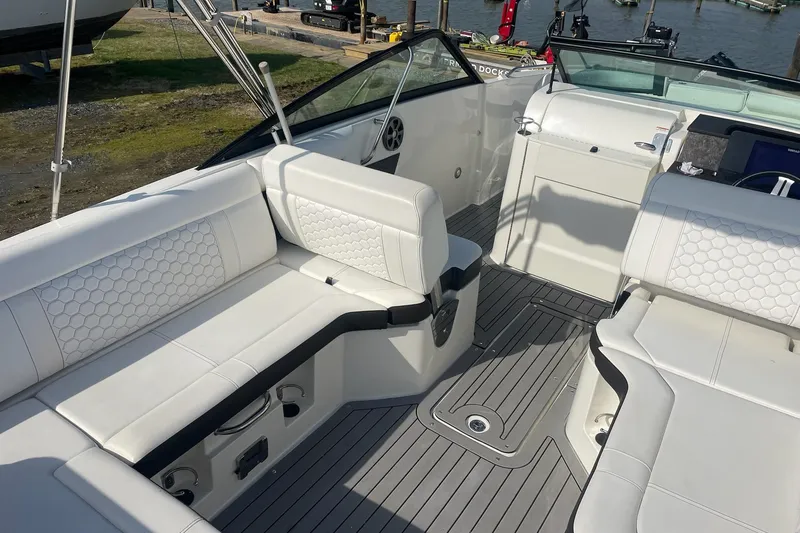 Slide: The Image of 2019 Sea Ray SDX 250 boat interior with white seating and sleek design. - 16
