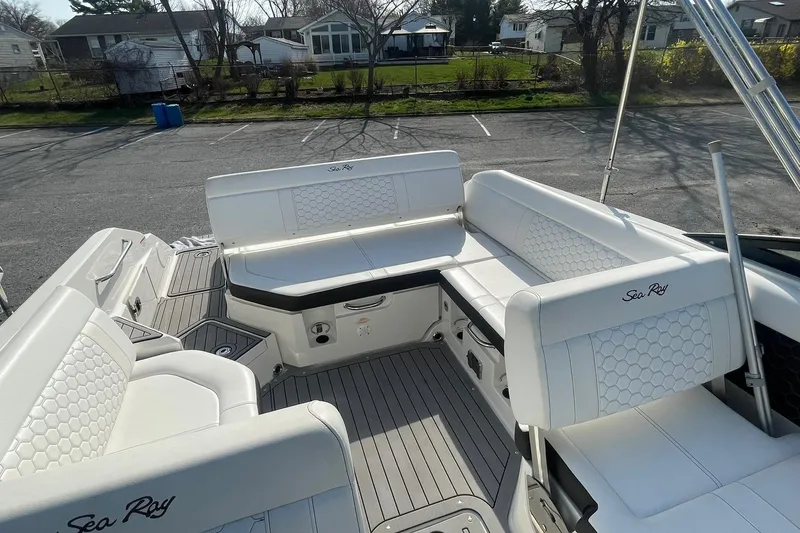 Slide: The Image of 2019 Sea Ray SDX 250 boat interior with white seating and hexagonal patterns. - 17
