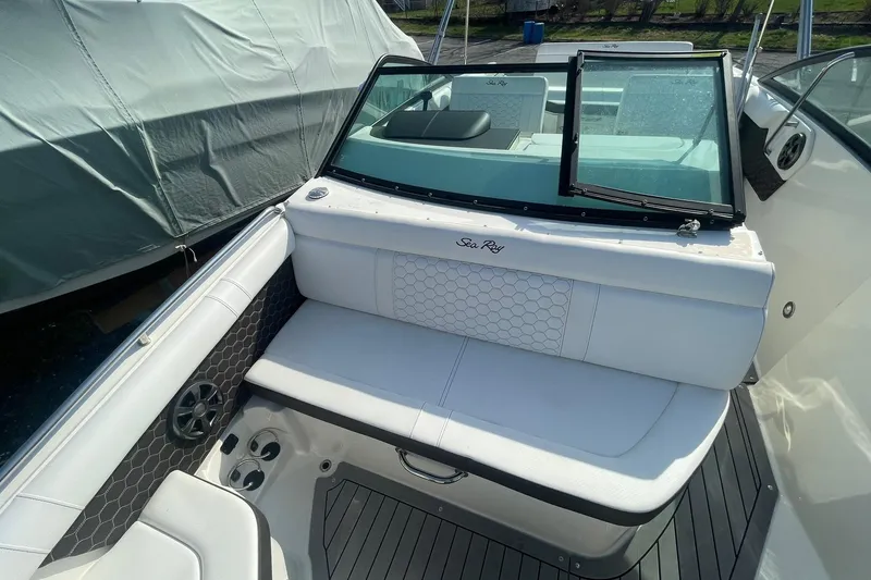 Slide: The Image of 2019 Sea Ray SDX 250 boat interior with white seating and open windshield. - 19