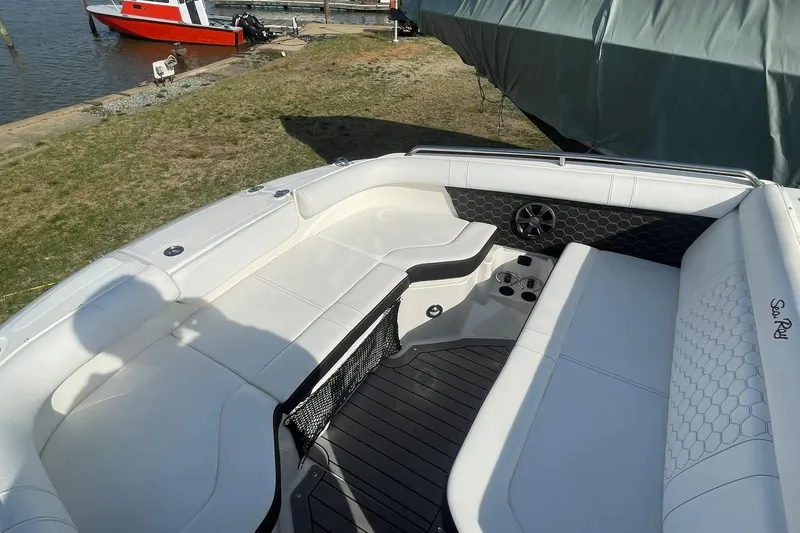 Slide: The Image of 2019 Sea Ray SDX 250 boat interior with white seating and cup holders. - 20