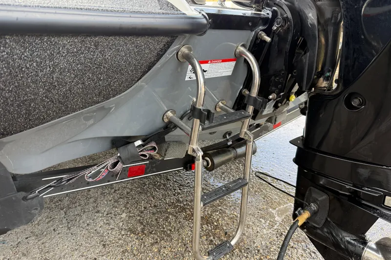 Slide: The Image of Rear view of a 2016 Stratos 176 VLO boat with a metal ladder and motor. - 10