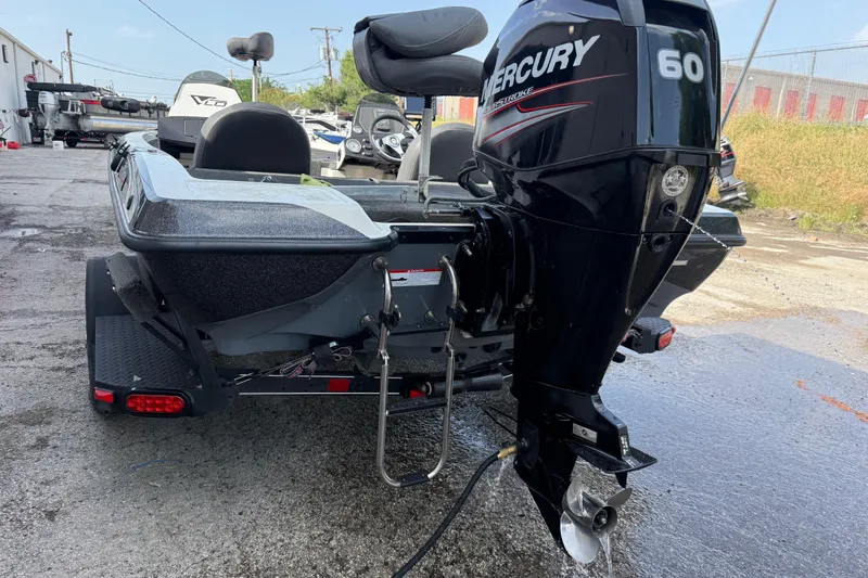 Slide: The Image of 2016 Stratos 176 VLO boat with Mercury 60 outboard motor, parked outdoors. - 11