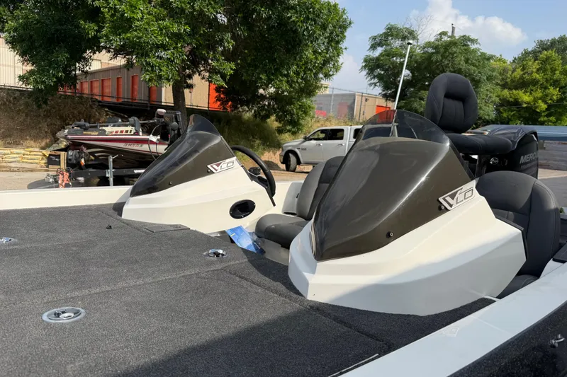 Slide: The Image of 2016 Stratos 176 VLO boat with dual consoles, parked outdoors. - 16