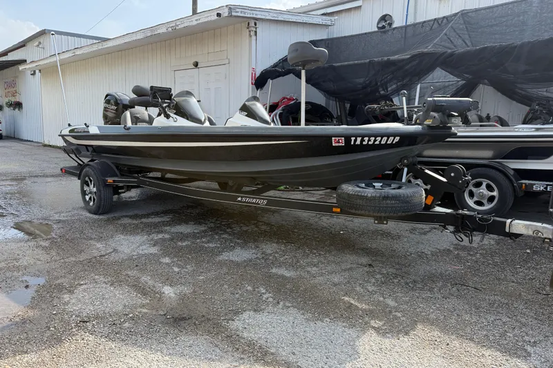 The Image of 2016 Stratos 176 VLO boat on trailer, parked outside a building. - 2