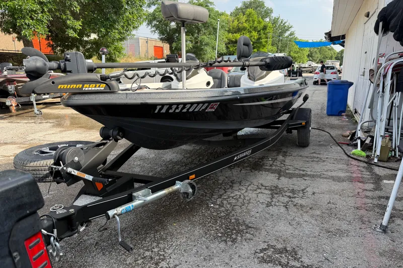 Slide: The Image of 2016 Stratos 176 VLO boat on trailer with Minn Kota motor, parked outdoors. - 20
