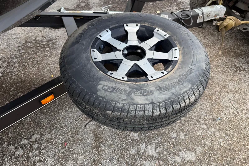 Slide: The Image of Trailer tire and wheel on a 2016 Stratos 176 VLO, parked on asphalt. - 24
