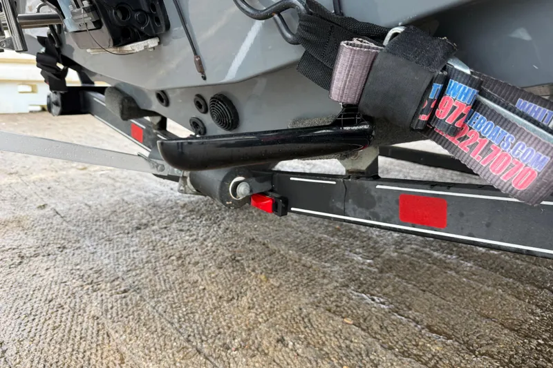 Slide: The Image of 2016 Stratos 176 VLO trailer wheel with black and silver rim on wet pavement. - 37