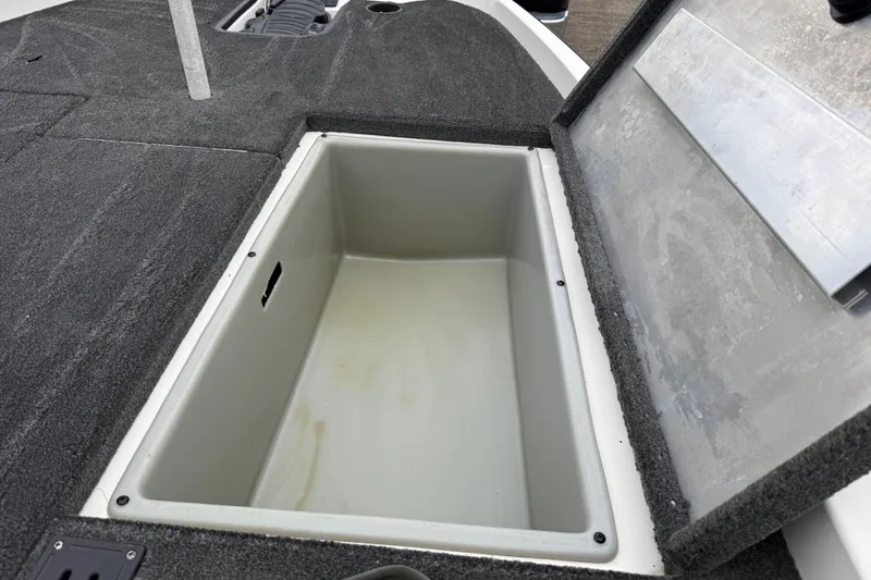 Slide: The Image of 2016 Stratos 176 VLO boat interior with open storage compartment and carpeted deck. - 40