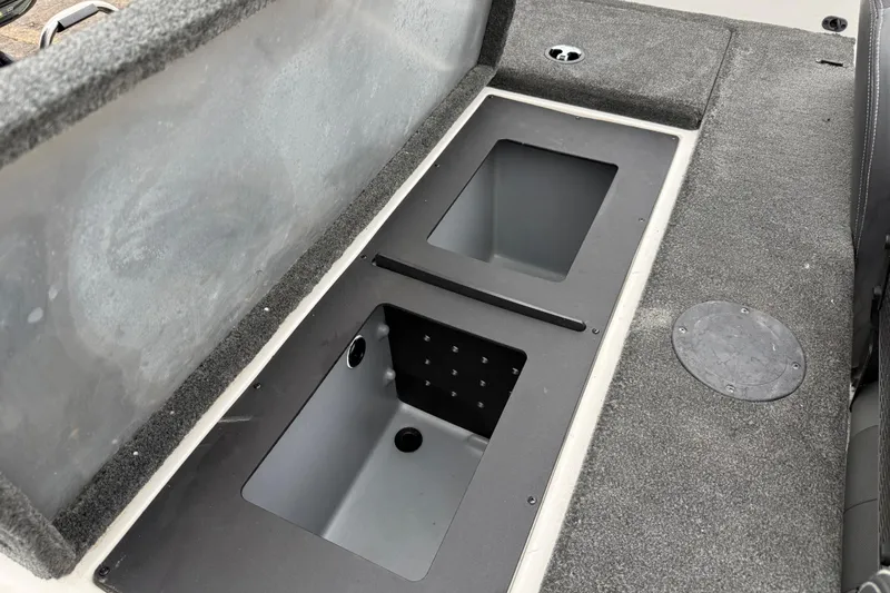Slide: The Image of 2016 Stratos 176 VLO boat storage compartment with gray carpeted interior. - 42