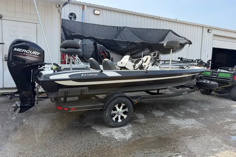Slide: The Image of 2016 Stratos 176 VLO fishing boat with Mercury engine on trailer, parked outside a garage. - 6