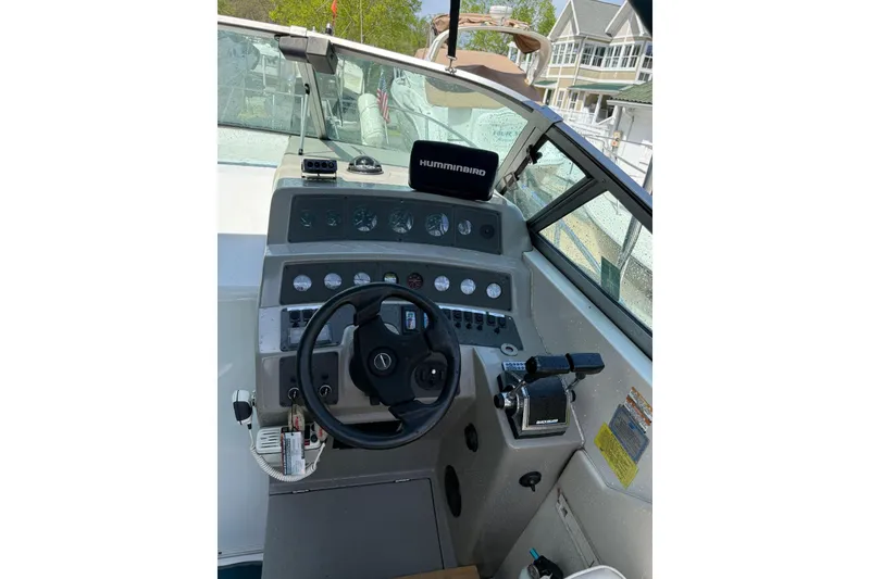 Slide: The Image of Cockpit of 1995 Chaparral Signature 310 boat with steering wheel and control panel. - 15