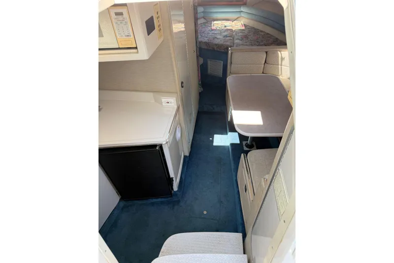 Slide: The Image of Interior of 1995 Chaparral Signature 310 boat with kitchenette and seating area. - 22