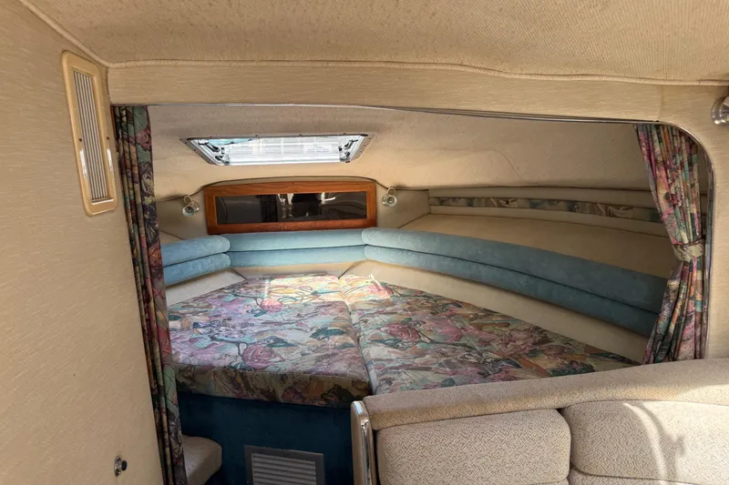 Slide: The Image of Interior cabin of 1995 Chaparral Signature 310 boat with floral upholstery and skylight. - 26