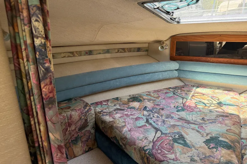 Slide: The Image of Interior of 1995 Chaparral Signature 310 boat with floral upholstery and cozy seating. - 27