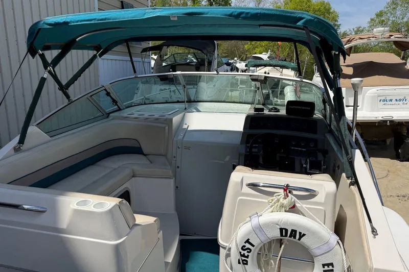 Slide: The Image of 1995 Chaparral Signature 310 boat interior with teal canopy and seating. - 28