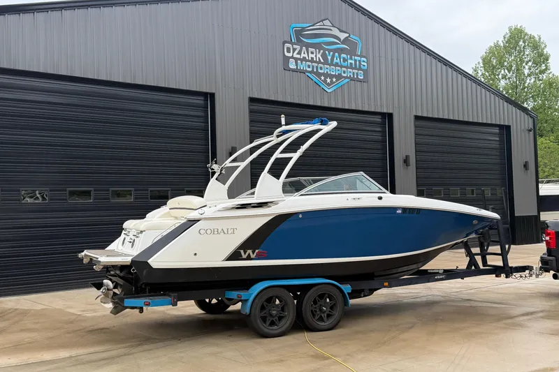 The Image of 2014 Cobalt 24SD WSS boat on trailer at Ozark Yachts dealership. - 1