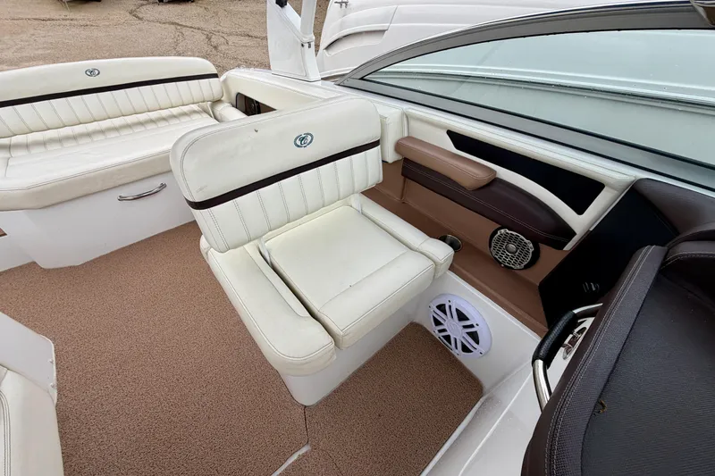 Slide: The Image of 2014 Cobalt 24SD WSS boat interior with white seating and brown accents. - 12