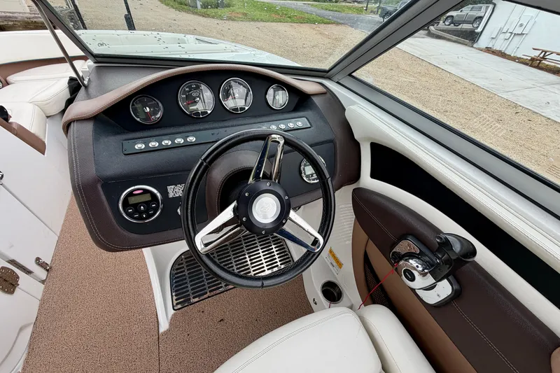 Slide: The Image of 2014 Cobalt 24SD WSS boat dashboard with steering wheel and instrument panel. - 14